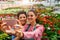 Portrait of two beautiful young women entrepreneurs in flower greenhouse