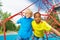 Portrait of two boys stand on red ropes