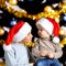 Portrait of two brothers in the new year Santa hats