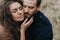 Portrait of two caucasian lovers. Young couple is hugging on autumn day outdoors. A bearded man and curly woman in love. Valentine