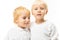 Portrait of two charming blond brother little children in an embrace on a white background