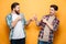 Portrait of a two cheerful young men standing