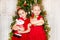 Portrait of two children girls around a Christmas tree decorated. Kid on holiday new year