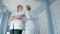 Portrait of Two Confident Doctors with Arms Folded Standing in the Hospital Room