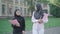 Portrait of two confident Muslim women walking on university yard and talking. Young female immigrants studying in