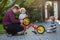 Portrait of two cute boys repairing bicycle wheel with father outdoors.