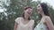 Portrait two cute smilling young women wear summer dresses standing in the top of rock and looking at amazing view of