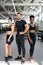 Portrait of two diverse athletic girls with trainer in gym