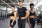 Portrait of two diverse athletic girls with trainer in gym