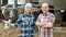 Portrait of two farmers near cows barn