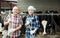Portrait of two farmers near cows barn