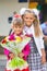 Portrait of two girls in school September 1 - first-grader and her younger sister with a bouquet in hands