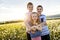 Portrait of two happy cheerful brothers and sister at sunset, outdoor