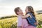 Portrait of two happy cheerful brothers and sister at sunset, outdoor