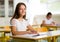 Portrait of two happy schoolgirls in a classroom