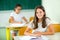 Portrait of two happy schoolgirls in a classroom