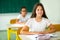 Portrait of two happy schoolgirls in a classroom