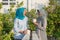 Portrait of two hijab  women drinking tea in front of the house and talking