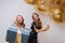 Portrait two joyful excited gorgeous women with long curly hair celebrating birthday party on white background. Big