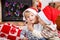 Portrait of two little sibling boy in santa hats, indoor