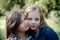 Portrait of two long haired preteen girls while smiling.