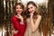 Portrait of two lovely pretty women in sparkly dresses