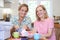 Portrait Of Two Mature Women Sewing Quilt Together