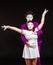 Portrait of two mime artists, isolated on black background. Young woman stands with risen hands, man hugs her from