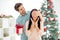 Portrait of two people shocked woman and her man give christmas gift package close eyes prepare x-mas surprise in house