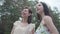 Portrait two pretty smilling happy young women wear summer dresses standing in the top of rock and looking at amazing