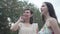 Portrait two pretty smilling young women wear summer dresses standing in the top of rock and looking at amazing view of