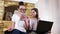 Portrait of two pretty young girls using gadgets at home, friends socializing at home with devices