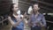 Portrait two professional cute female farmer workers on the cow farm checking quality of the milk in the bottle. One