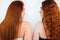 Portrait of two redheaded young women both standing back half a turn on isolated white backgroung, beauty and style