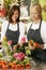 Portrait Of Two Sales Assistants In Florists Shop