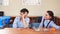 Portrait of two schoolchildren sitting by one desk