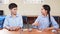 Portrait of two schoolchildren sitting by one desk