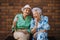 Portrait of two senior female friends in the city, eating ice cream on a hot summer day.