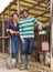 Portrait of two successful farm workers next to chicken coop