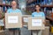 Portrait of two volunteers holding a donations box