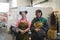 portrait of two welders holding welding masks in their hands and preparing for hard work in a factory