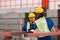 Portrait of two workers using digital tablet stand in front of the red steel