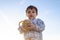 Portrait of two years old toddler holding bascet with two easter eggs - golden hour