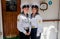 Portrait of two young beautiful ladies sailors in official marine uniform on the deck of the sailboat.