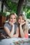 Portrait of two young beautiful women sitting near a table. Happy persons.