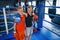 Portrait of two young boys in protective gloves standing together on boxing ring