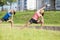 Portrait of Two Young Feale Sportswomen Having Stretching Exercises Outdoors