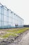 Portrait of two young female farmers carrying newly harvest tomatoes in crate while walking at greenhouse