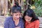 Portrait of two young Indian females reading shocking news on a phone