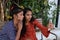 Portrait of two young Indian females taking a selfie while sitting on a bench